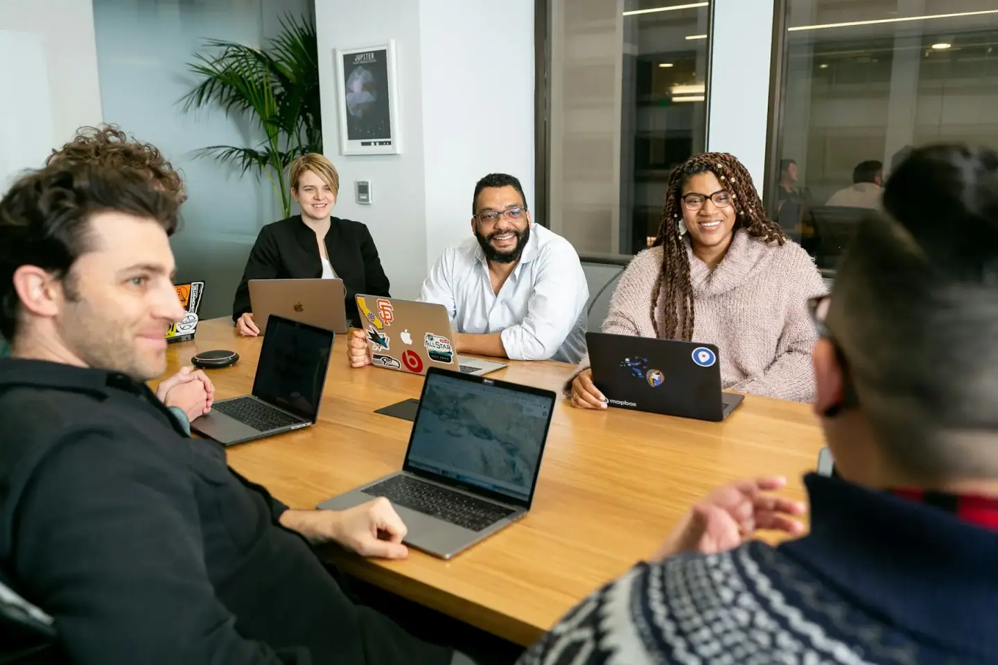 marketers gathered around a laptop, generating leads
