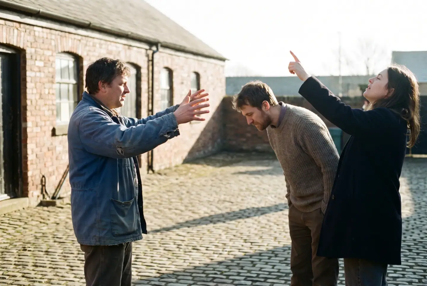 Three people in animated discussion, gesturing and leaning toward each other.