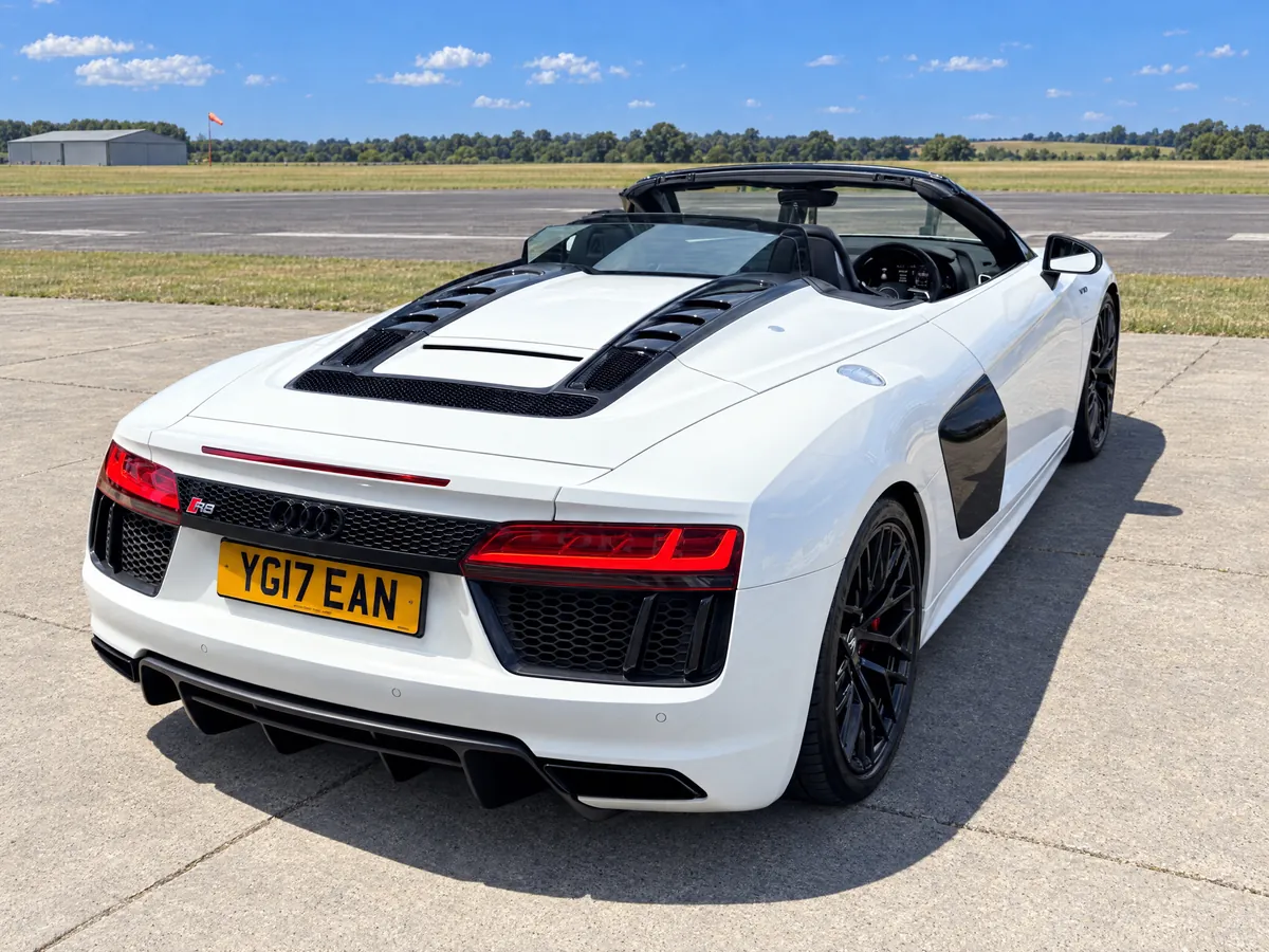 Audi R8 Spyder from above with the roof down, showing the engine cover louvres