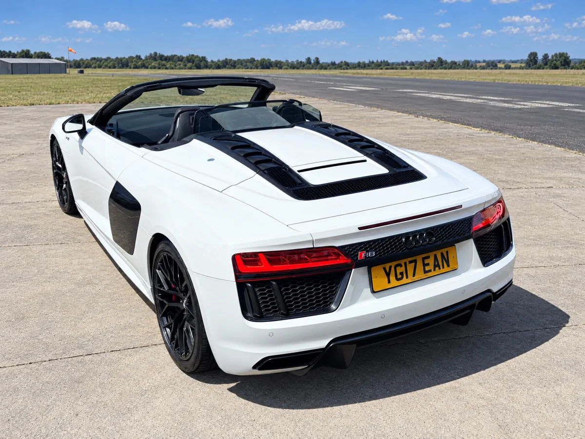 Rear three-quarter view of the Audi R8 Spyder showing the V10 engine cover and LED tail lights