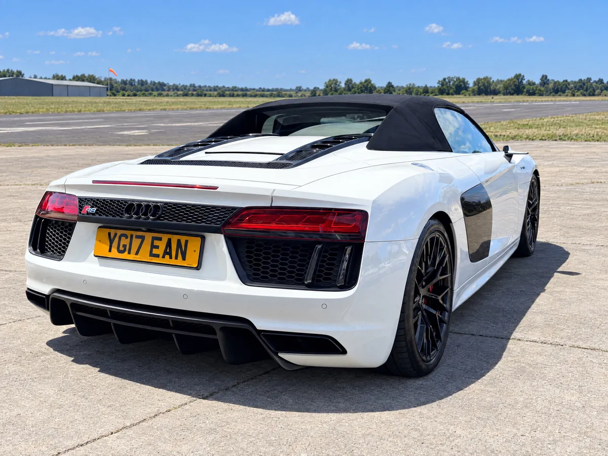 Rear three-quarter view of the Audi R8 Spyder, roof up, with the rear diffuser in view